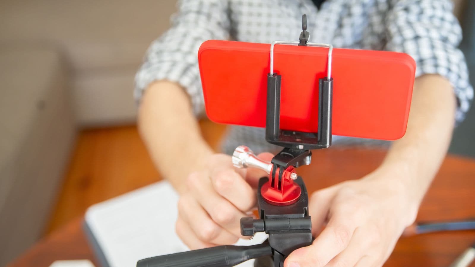 A creator filming a hotel room with a phone on a small tripod