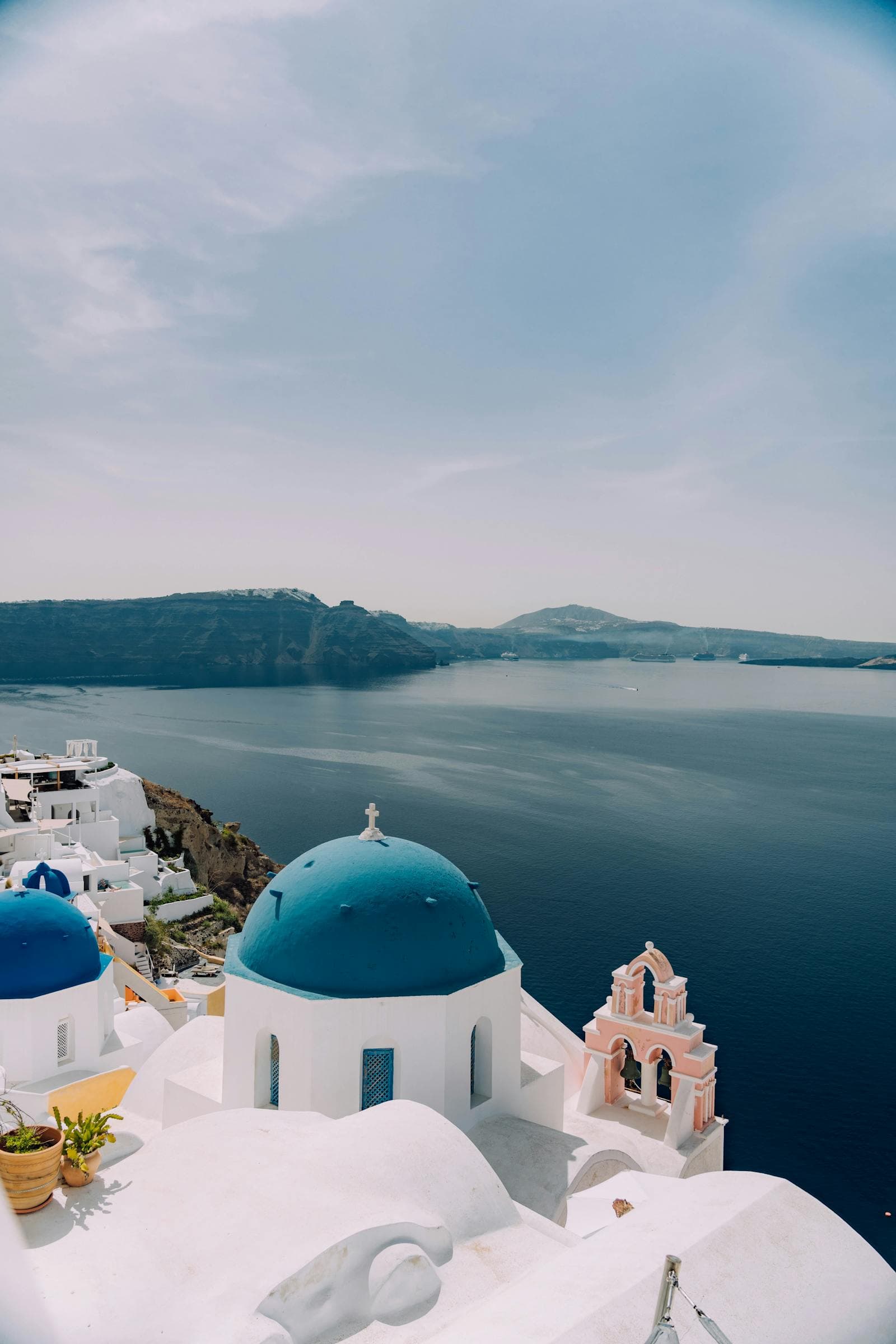 Whitewashed dome and bell tower above the caldera in Santorini, Greece